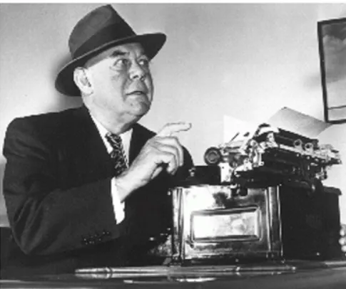 Grantland Rice at his typewriter, looking up from his work