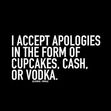 Black sign in white letters: I accept apologies in the form of cupcakes, cash, or vodka