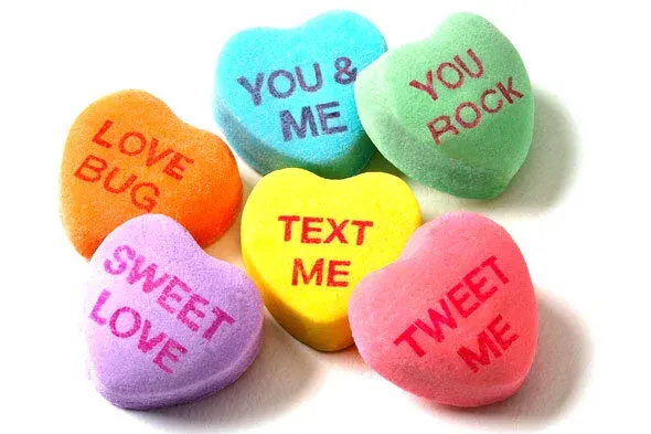 Candy conversation hearts reading Love Bug, You & Me, You Rock, Text Me, Sweet Love and Tweet Me