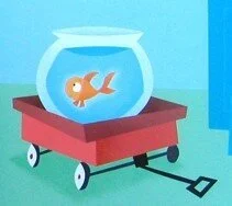Norman the goldfish in his bowl, riding in a red wagon